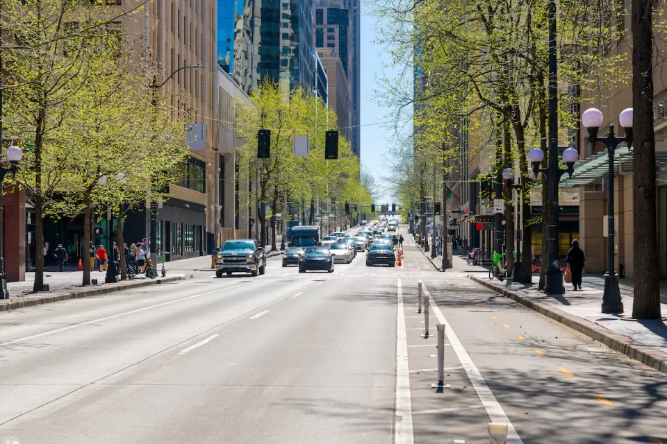 Street view of 4th Avenue, a commercial street of shops and restaurants through the city center of downtown Seattle, Washington.